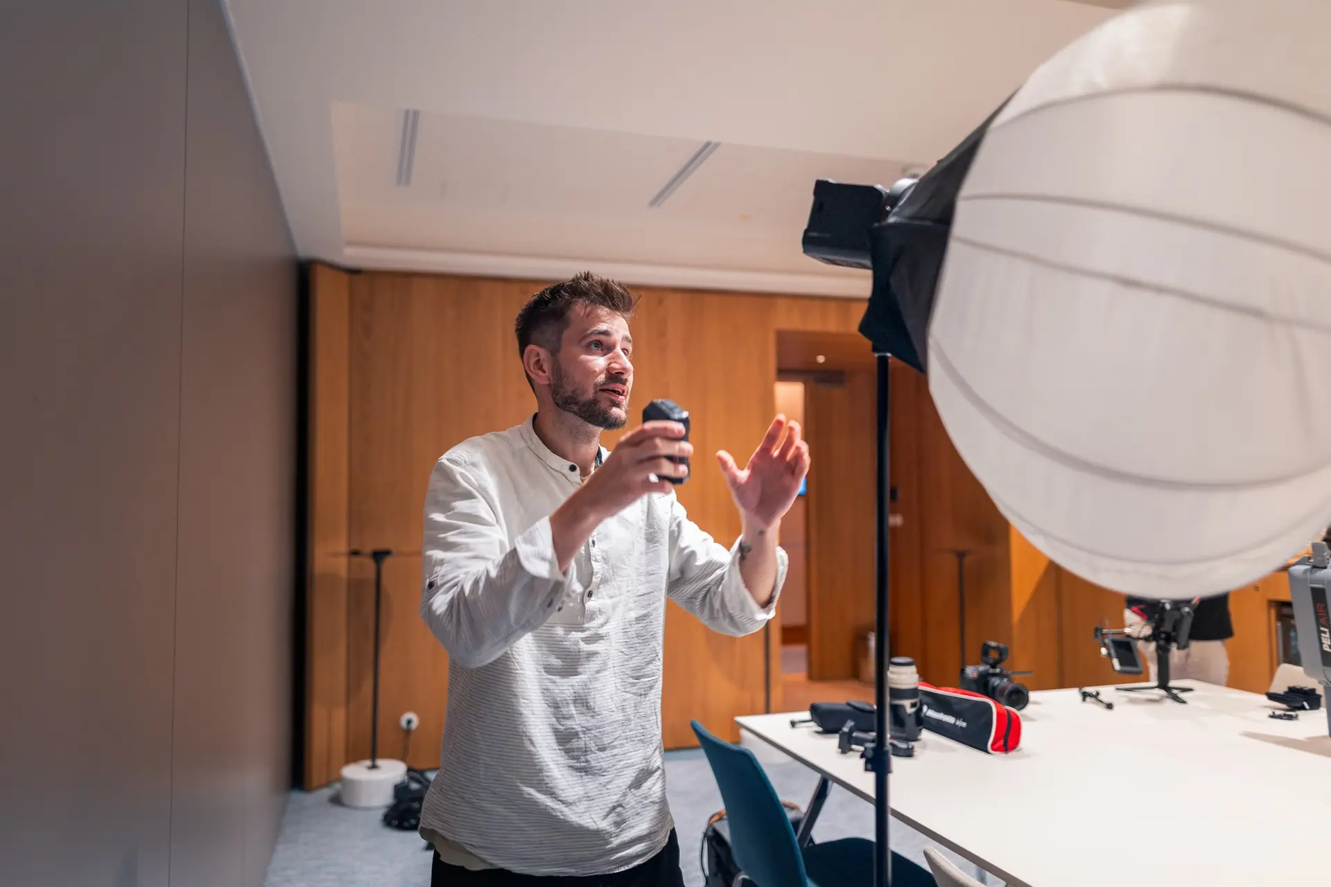 Tomáš Berka giving directions on set, next to a softbox light
